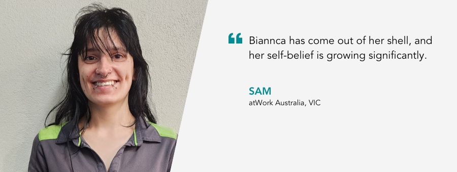 Biannca has a big grin standing in her grey work uniform. Her In-Work Support consultant Sam says “Biannca has come out of her shell, and her self-belief is growing significantly”.  